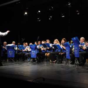 Zdjęcie przedstawia orkiestrę podczas koncertu na sali widowiskowej TCK